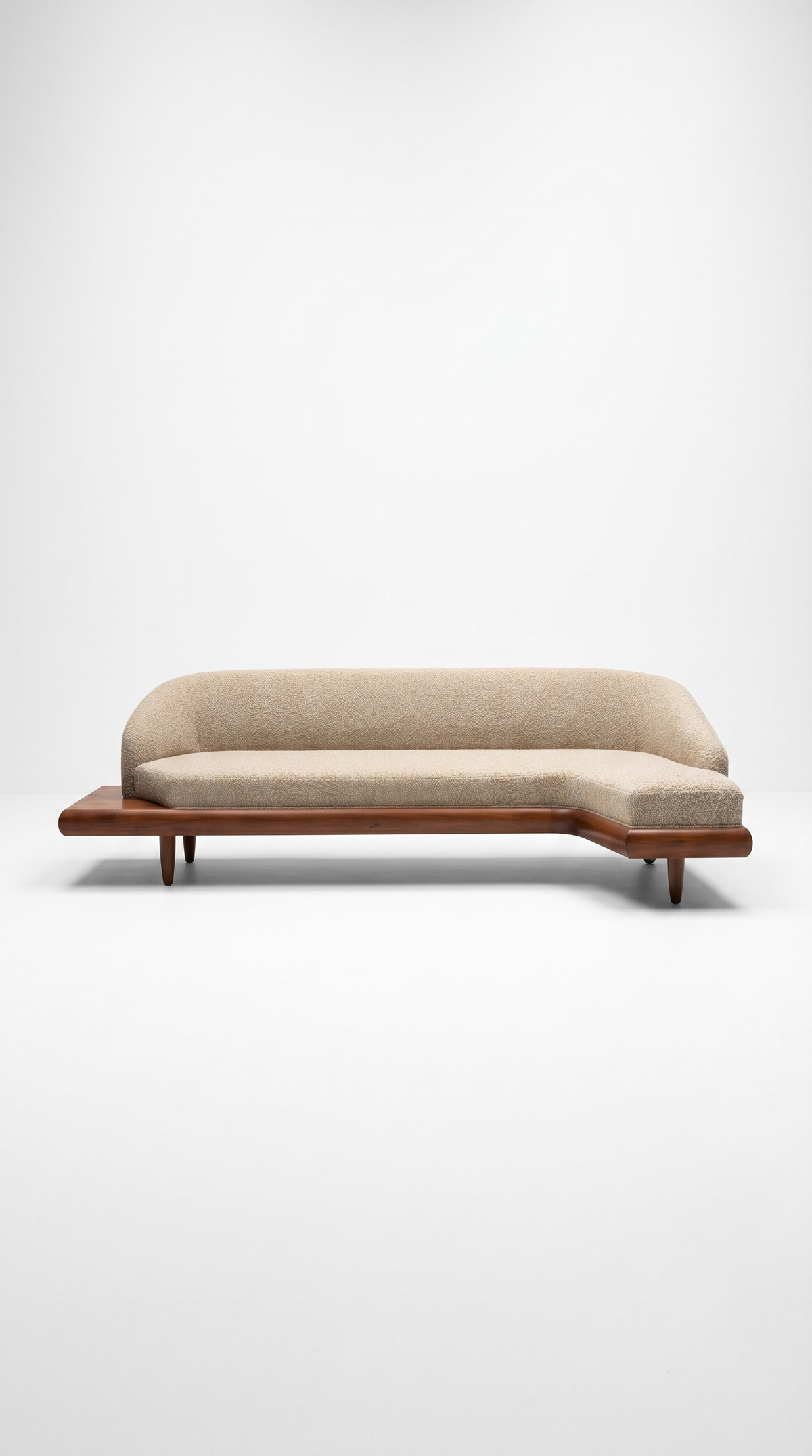 The Élan Curved Sectional styled in a modern, open-concept living room paired with a neutral rug and minimalist decor, emphasizing its role as a contemporary sculptural centerpiece.